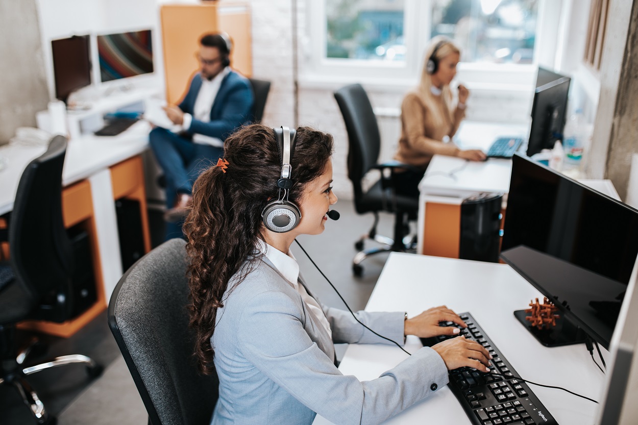 Team of call center employees working together on office. foreigner